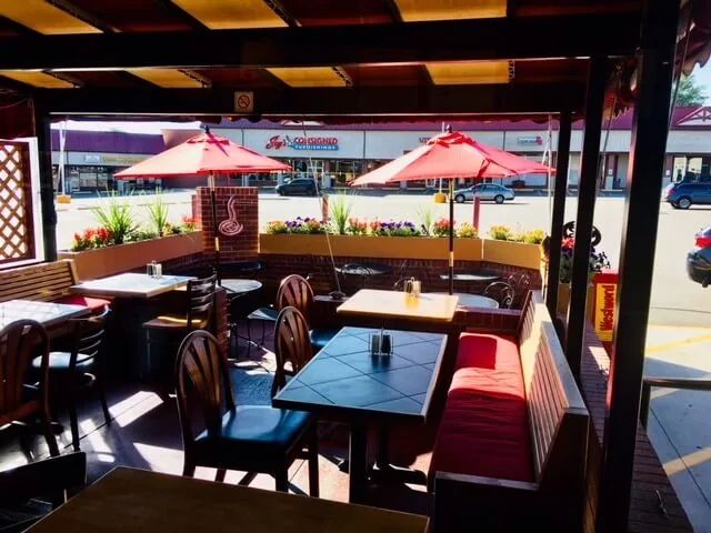 The patio at Duffeyrolls Bakery & Café – Hampden, under red umbrellas.