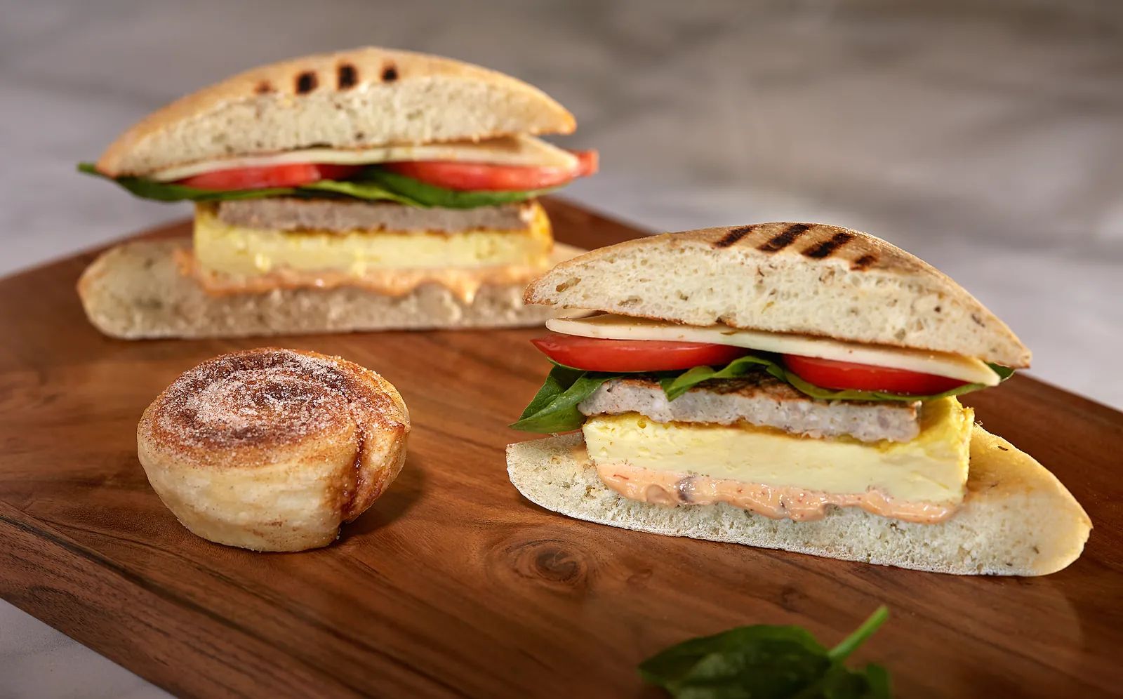 Snappy Sausage breakfast sandwich with spinach and tomato, and a mini Duffeyroll.