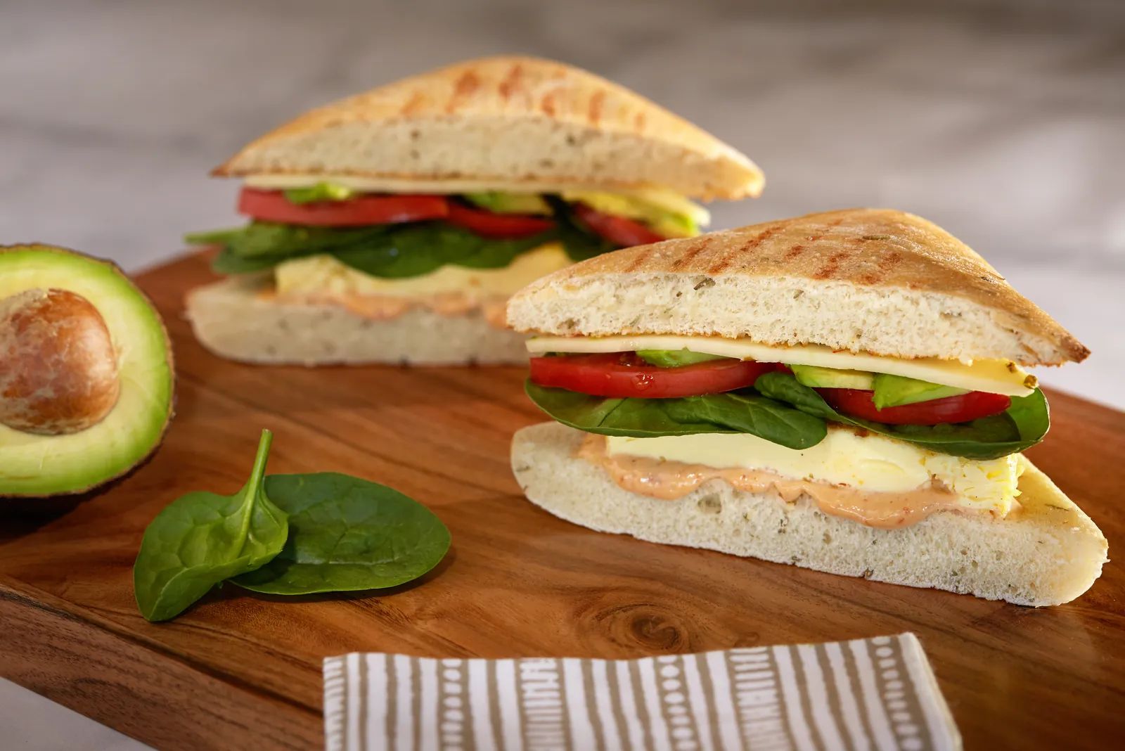Veggie Roonie breakfast sandwich with spinach, tomato and avocado.